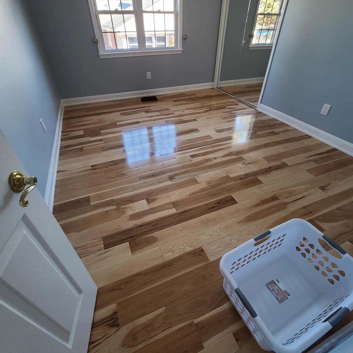 Hickory hardwood floor with mixed light and warm planks reflecting natural light